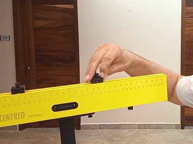 Hand adjusting an end stop on the yellow tool